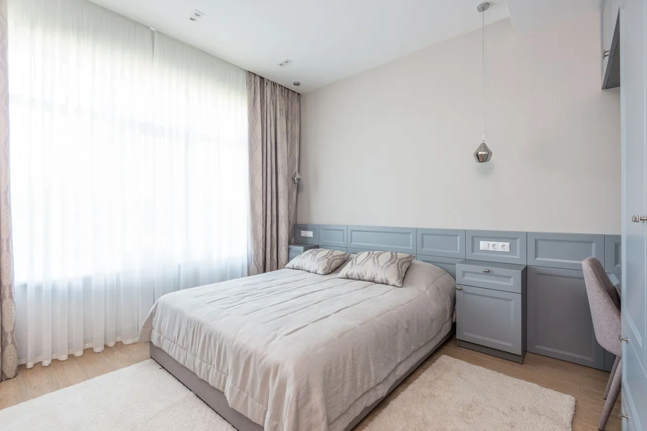 Elegant hotel bedroom with minimalist design and calming neutral tones.